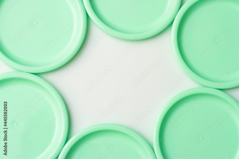 Plastic dishes in mint color on white background Plastic dishes in mint color on white background