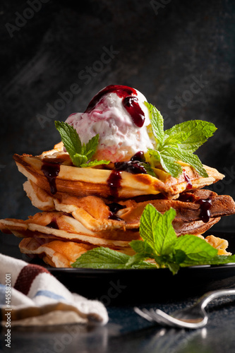 Stack of homemade waffles with ice cream