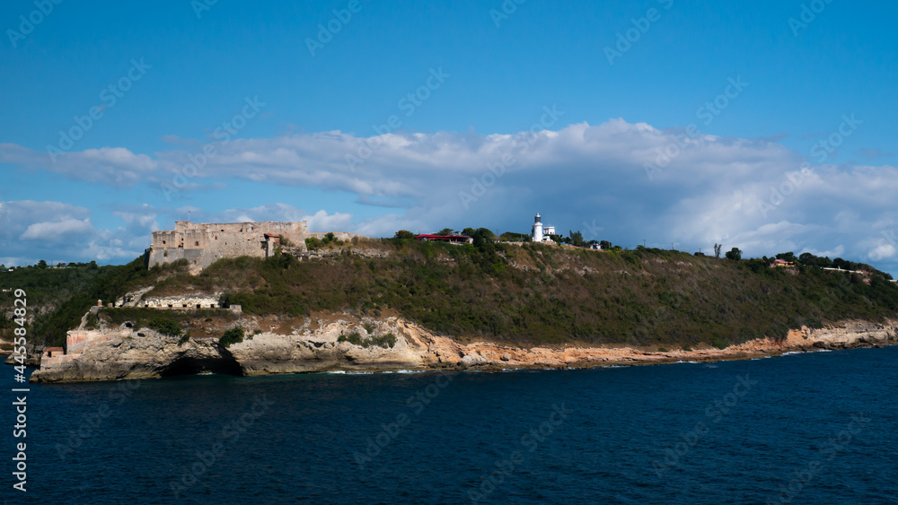 View of the Castillo del Morro castle from the sea side in the Santiago de Cuba and light house for entrance to the bay.