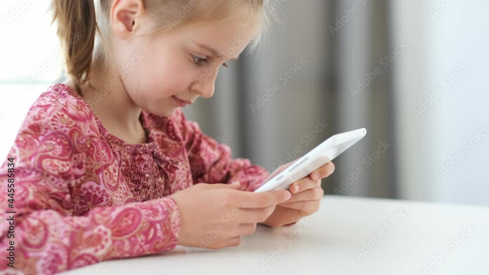 Digital tablet used by little girl during school lesson Digital tablet used by little girl during school lesson