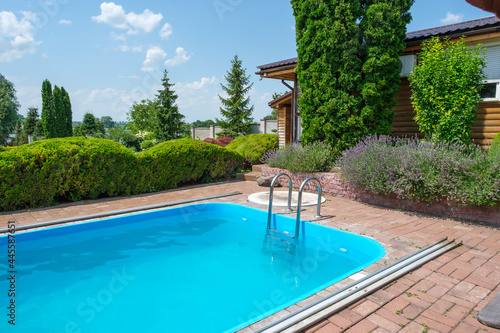 Wallpaper Mural Swimming pool and garden with nicely trimmed bushes and stones in backyard. Landscape design. High quality photo Torontodigital.ca