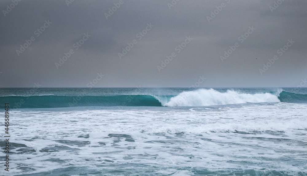 Stormy ocean view with big waves breaking on the Atlantic Ocean in Spain. Winter Atlantic storm with big breaking waves