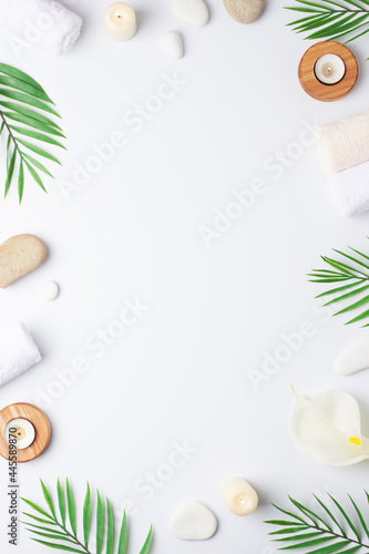 Home decoration with candles and flowers over white wall. Interior design concept. Close up, copy space