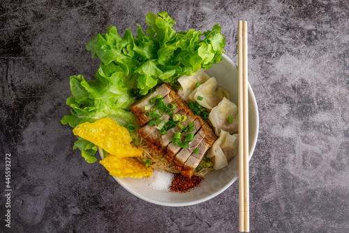 Bowl of wonton egg noodle with Crispy pork topping without soup