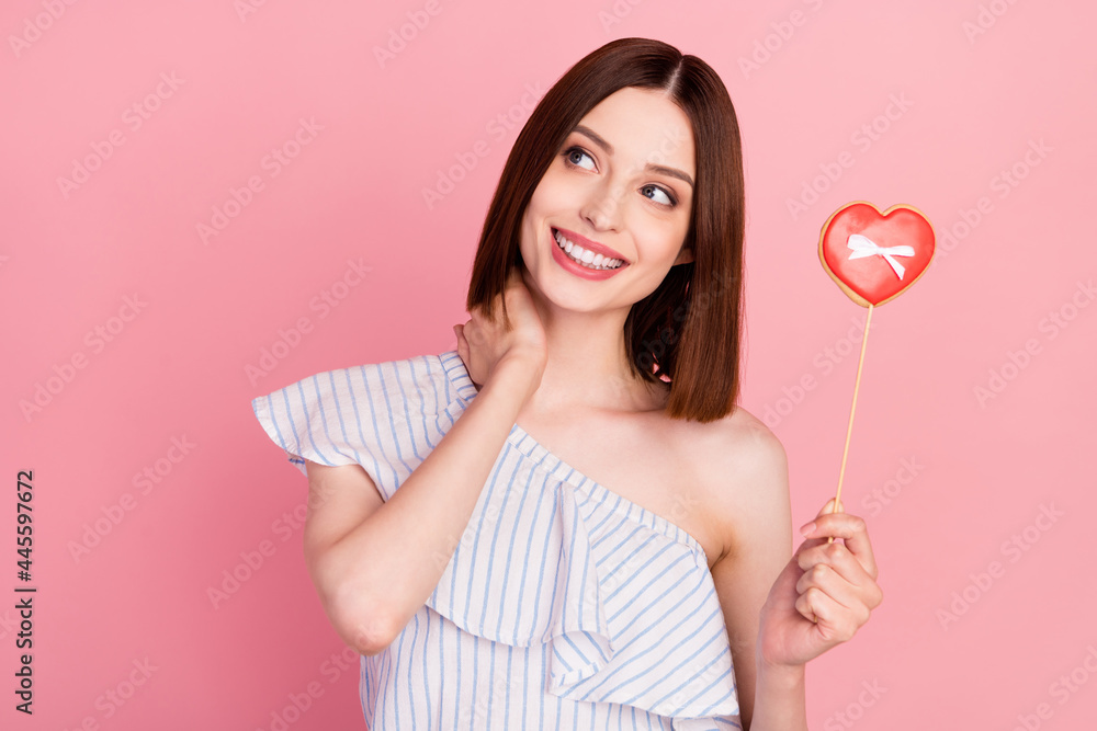 Photo of young girl happy positive smile hand touch neck dream heart shape candy love isolated over pink color background Photo of young girl happy positive smile hand touch neck dream heart shape candy love isolated over pink color background
