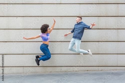 multi-ethnic friends jumping at the same time