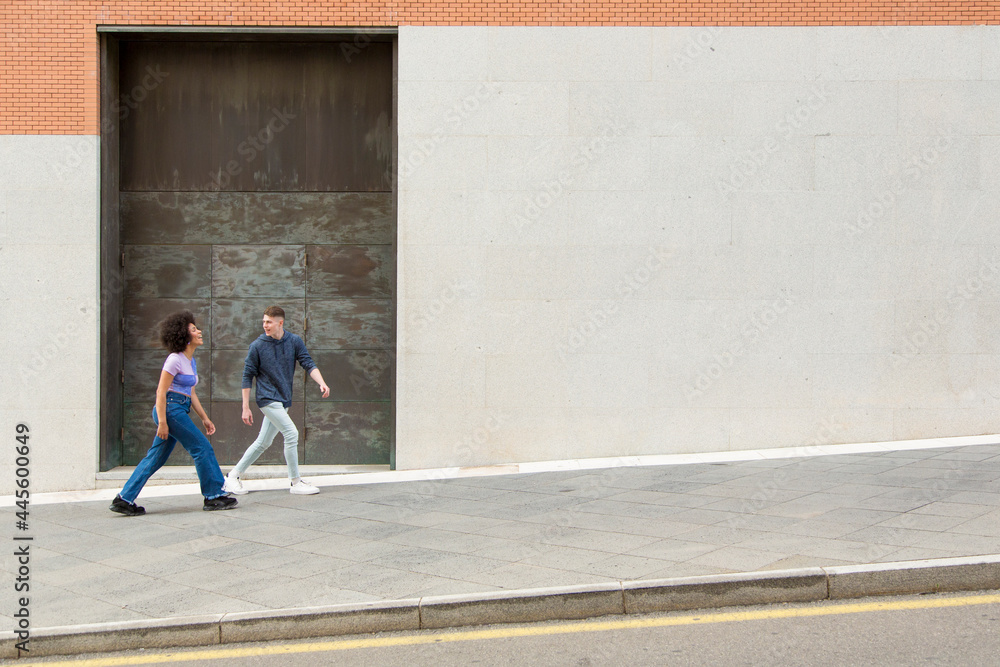 couple white man and black woman walking having fun and laughing 20s couple white man and black woman walking having fun and laughing 20s