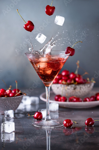 Glass of cherry juice with ice and splash