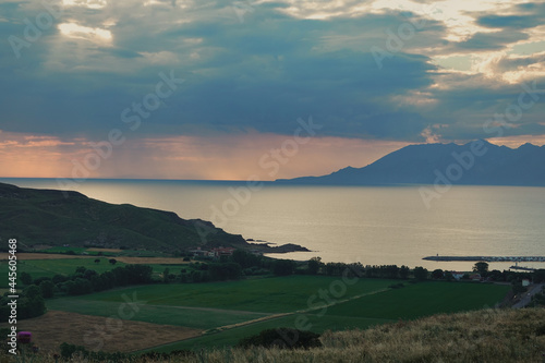 Distant view of Samothrace island at sunset from Kalekoy Harbour on Imbros Gokceada, Çanakkale Turkey
