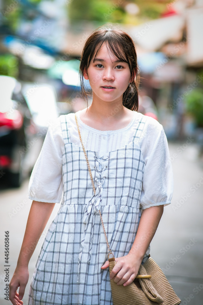 Portrait of teenager girl happy walking on city streets on a sunny day of summer,