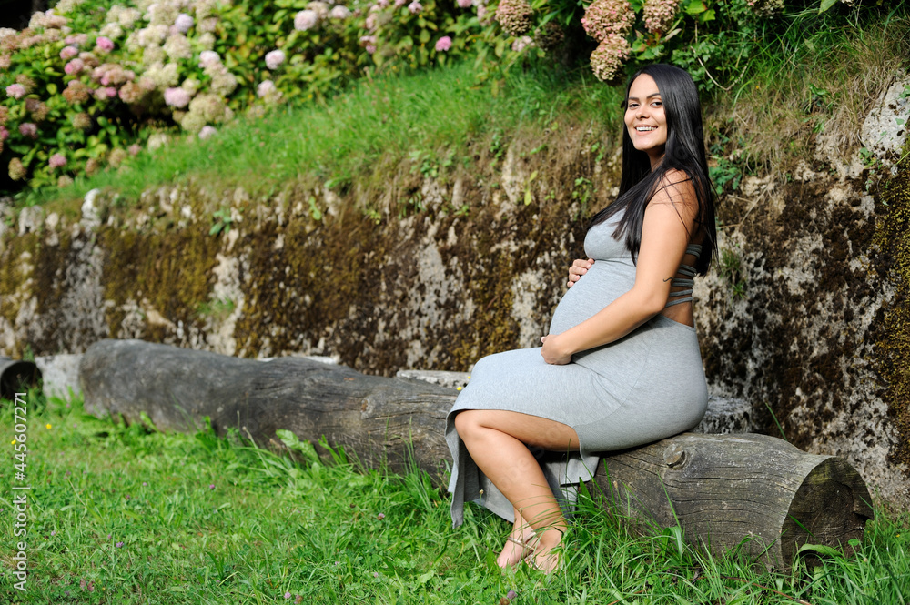 Young pregnant Brazilian woman touching her belly Young pregnant Brazilian woman touching her belly