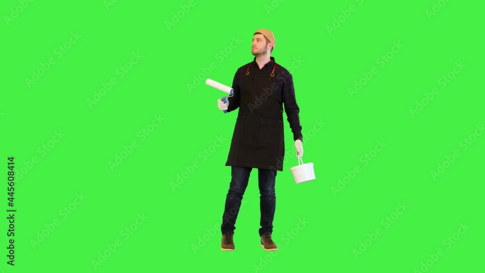 Renovation worker turn around checking painted walls in room or apartment with happy confident smile on a Green Screen, Chroma Key. Renovation worker turn around checking painted walls in room or apartment with happy confident smile on a Green Screen, Chroma Key.