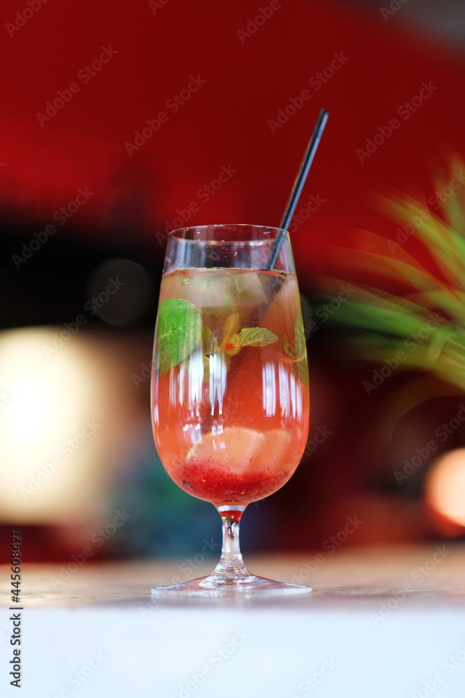 Fresh cocktail with lime, mint, raspberries and ice. Alcoholic, non-alcoholic drink-a drink at the bar in a nightclub.