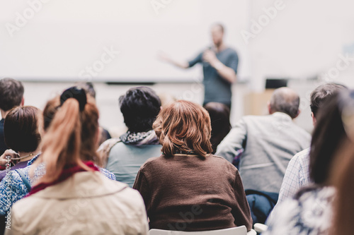 Man giving presentation in lecture hall at university.