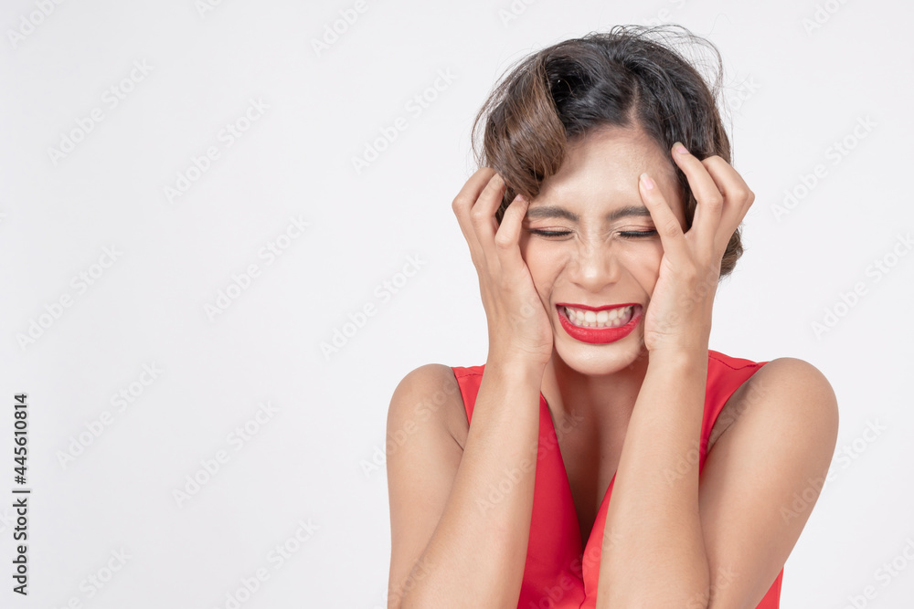 Portrait and close up face of young Asian woman used hands to head grotesquely on her hair because of the stress on white background Portrait and close up face of young Asian woman used hands to head grotesquely on her hair because of the stress on white background