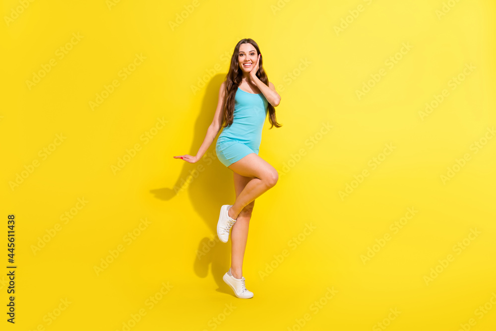 Full length body size view of attractive amazed cheerful girl dancing having fun posing isolated over bright yellow color background