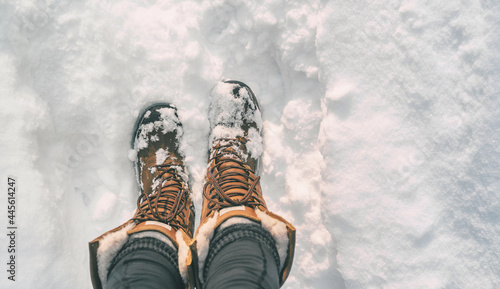 Winter hiking in Snow boots walking first person POV selfie of feet in deep cold snowfall in outdoors forest. Girl taking picture of her shoes.