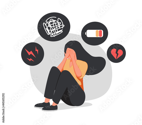 Young woman who suffers from mental health diseases is sitting on the floor. Girl surrounded by symptoms of depression.
