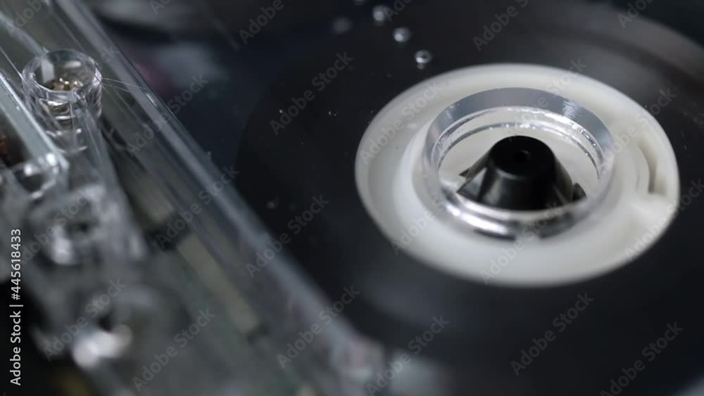 Audio cassette tape in use sound recording in the tape recorder. Vintage music cassette with a blank white , playing back in the player. Audio cassette tape in use sound recording in the tape recorder. Vintage music cassette with a blank white , playing back in the player.