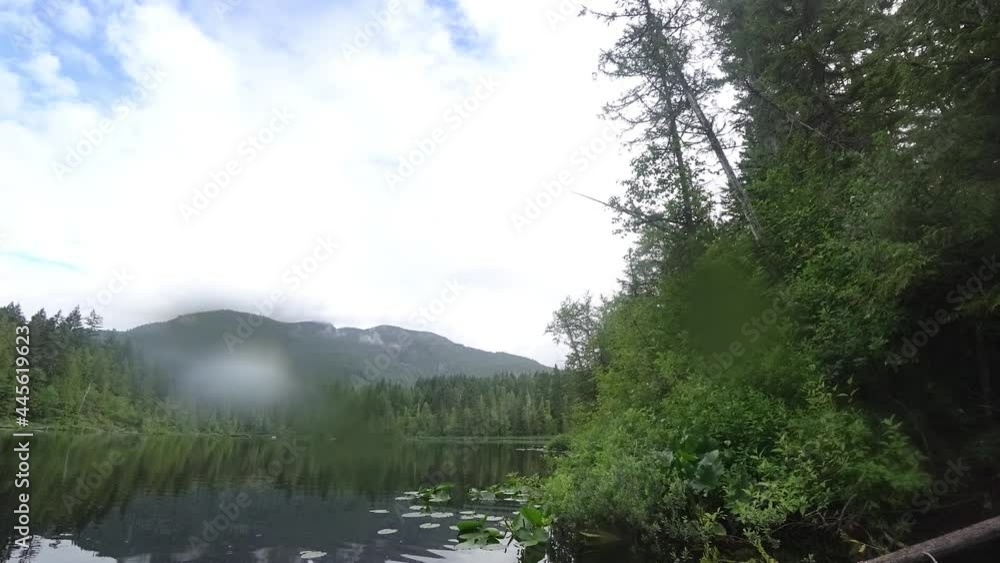 Timelapse of Canadian lake on a rainy day with forest and mountains around Timelapse of Canadian lake on a rainy day with forest and mountains around