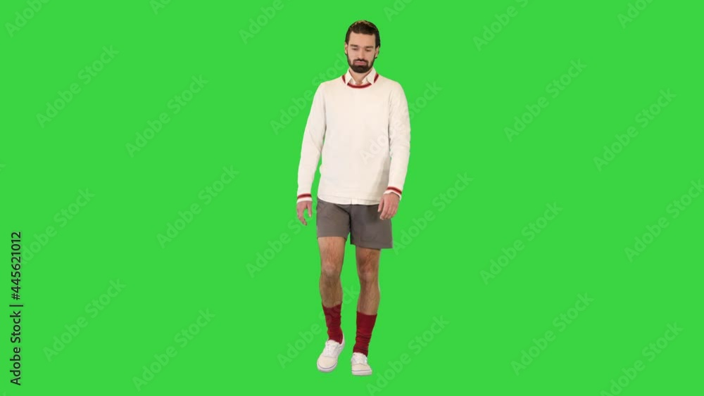 Handsome male tennis player walking on a Green Screen, Chroma Key. Handsome male tennis player walking on a Green Screen, Chroma Key.