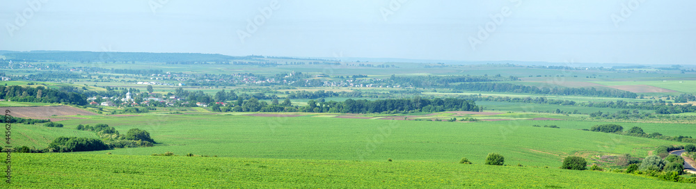 Beautiful panorama of agricultural fields and hills on a summer day in Ukraine