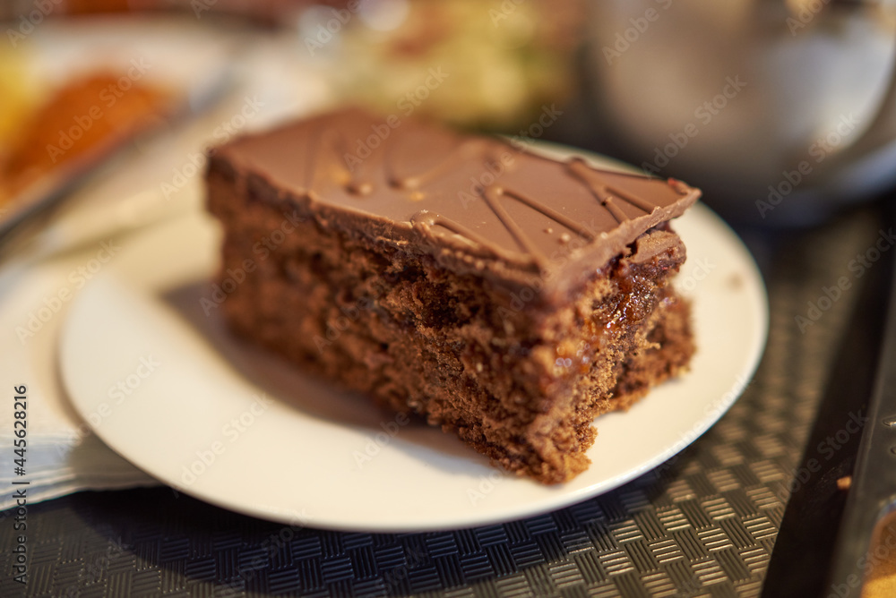 Piece of chocolate pie with icing and filling. Blur, bokeh Piece of chocolate pie with icing and filling. Blur, bokeh