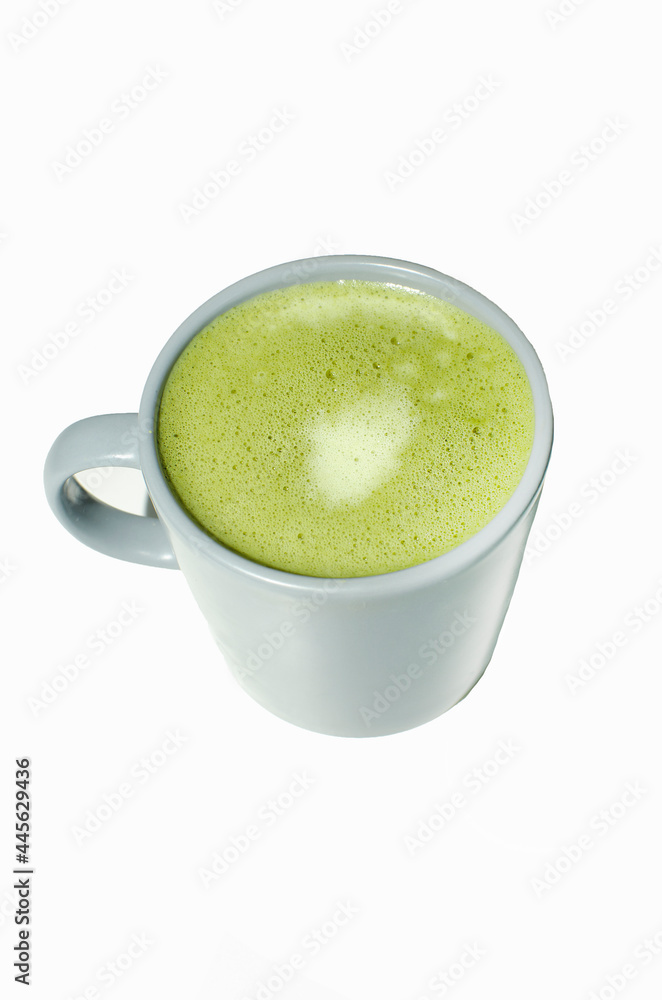 Matcha, green tea latte in a cup. white isolated background. Close up. Top view. Matcha, green tea latte in a cup. white isolated background. Close up. Top view.