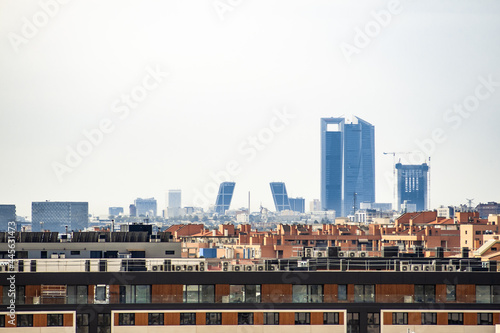 View of the Kio towers and the four Business Area Towers next to Plaza de Castilla on a cloudy day from the city of Madrid