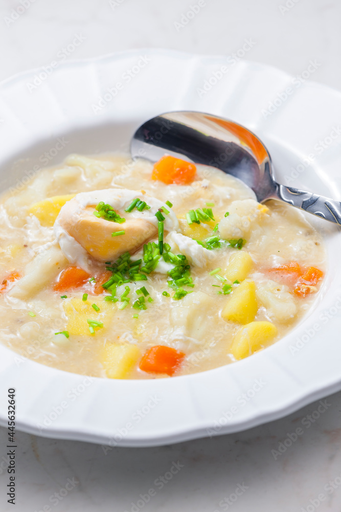 cauliflower soup with carrot, potatoes and poache egg