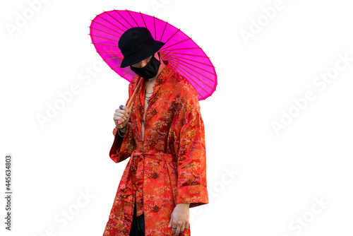 Positive man with dressed in street style clothes red kimono with chains around neck, black cap and black medical mask . Youth and lifestyle concept. isolated on white.