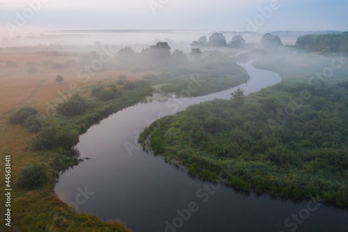 Obraz na płótnie Aerial view of winding river. Misty sunrise above the meadow. Beautiful landscape of nature. w salonie