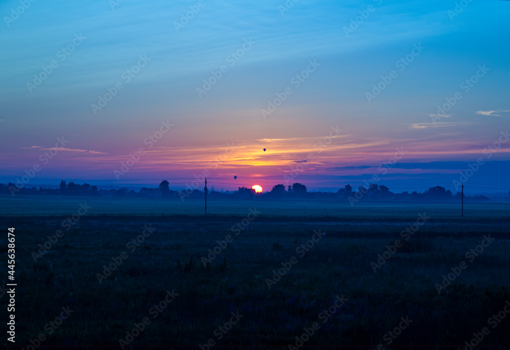 Fototapeta premium Calm beautiful sunrise over a rural field