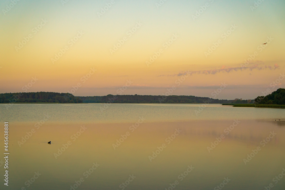 Calm beautiful sunrise over the lake with sky reflection in water Calm beautiful sunrise over the lake with sky reflection in water