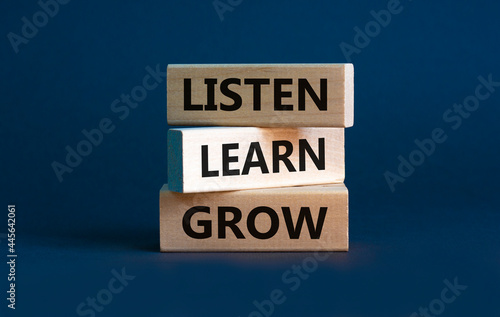 Listen, learn and grow symbol. Wooden blocks with concept words listen, learn, grow. Beautiful grey background, copy space. Business, educational and listen, learn, grow concept.