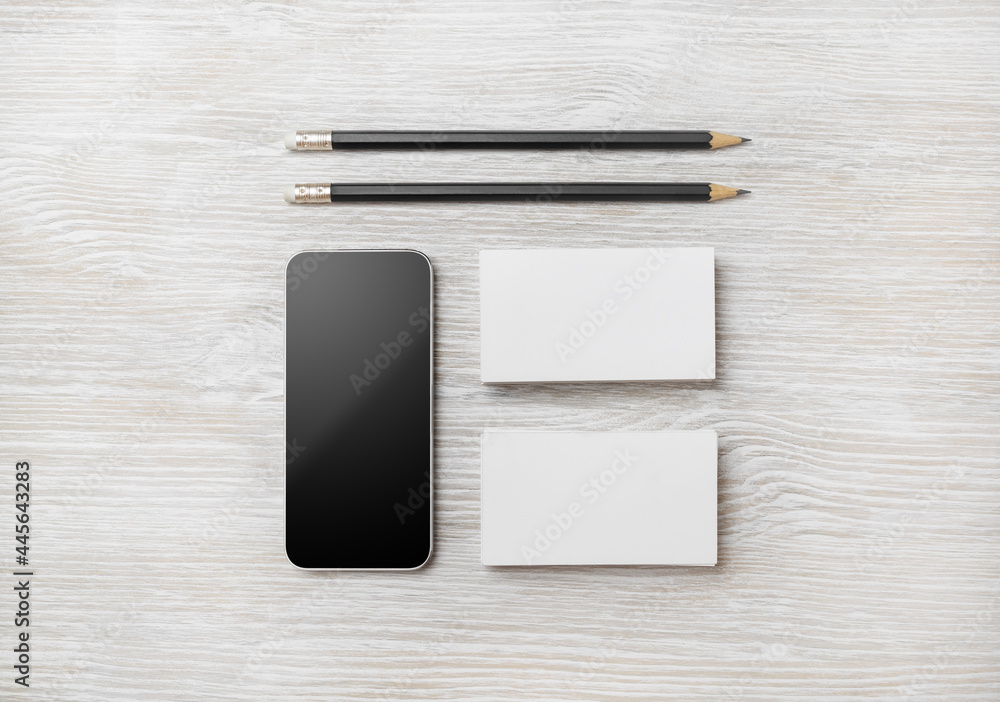 Branding stationery template. Blank business cards and pencil on light wood table background. Flat lay. Branding stationery template. Blank business cards and pencil on light wood table background. Flat lay.