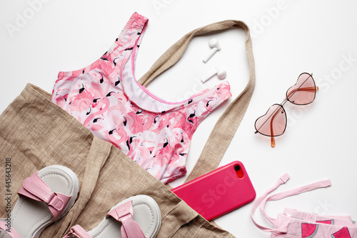 Fashion girl clothing and accessories for the beach on white background. Summer concept. Flat lay, top view. 