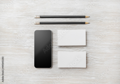 Branding stationery template. Blank business cards and pencil on light wood table background. Flat lay.