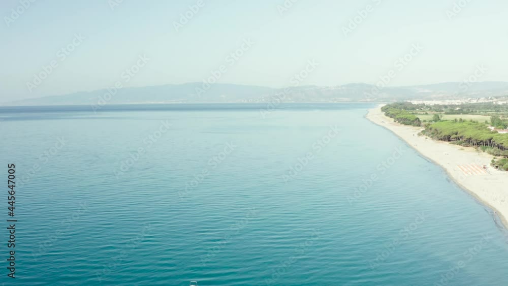Aerial view of beautiful sea and beach at sunny day, seascape and hill mountain on backgrond, Simeri Mare, Calabria, Southern Italy Aerial view of beautiful sea and beach at sunny day, seascape and hill mountain on backgrond, Simeri Mare, Calabria, Southern Italy