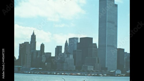 Archival of Manhattan skyline, sea view from Hudson river sightseeing cruise. Old Twin Towers skyscrapers and office buildings of New York city. United States America in 1976. photo