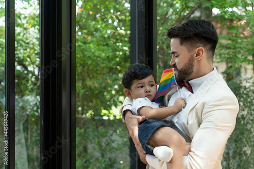 A males gay with rainbow pride flag teasing a lovely foster son photo