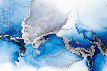 Blue silver abstract background of marble liquid ink art painting on paper . Image of original artwork watercolor alcohol ink paint on high quality paper texture .