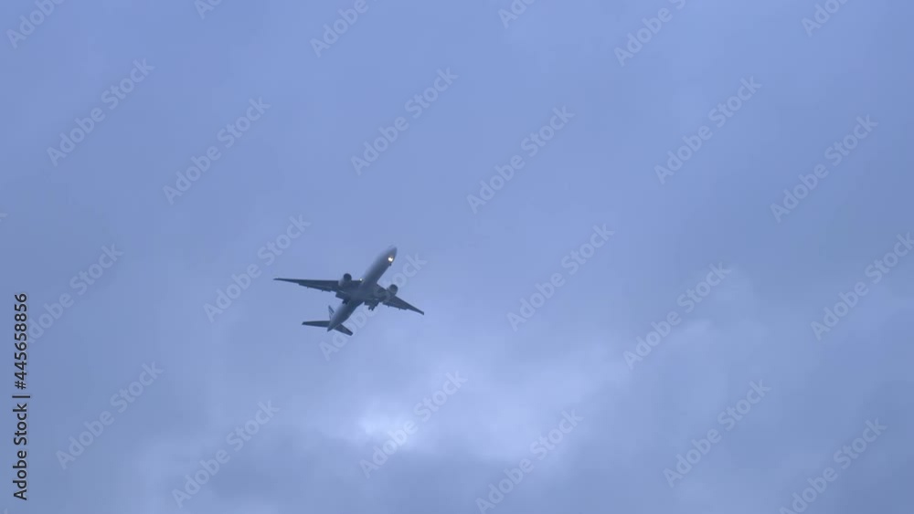 Low-angle shot of an airplane soaring by in the sky Low-angle shot of an airplane soaring by in the sky