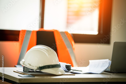 Working tools Engineer office desk with helmet at desk talbe photo