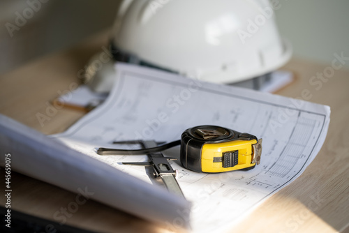 Working tools Engineer office desk with helmet at desk talbe photo