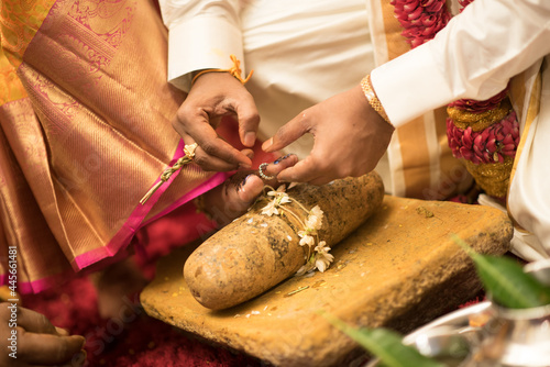 Traditional ritual of putting a ring on the bride's toe during a Hindu wedding ceremony