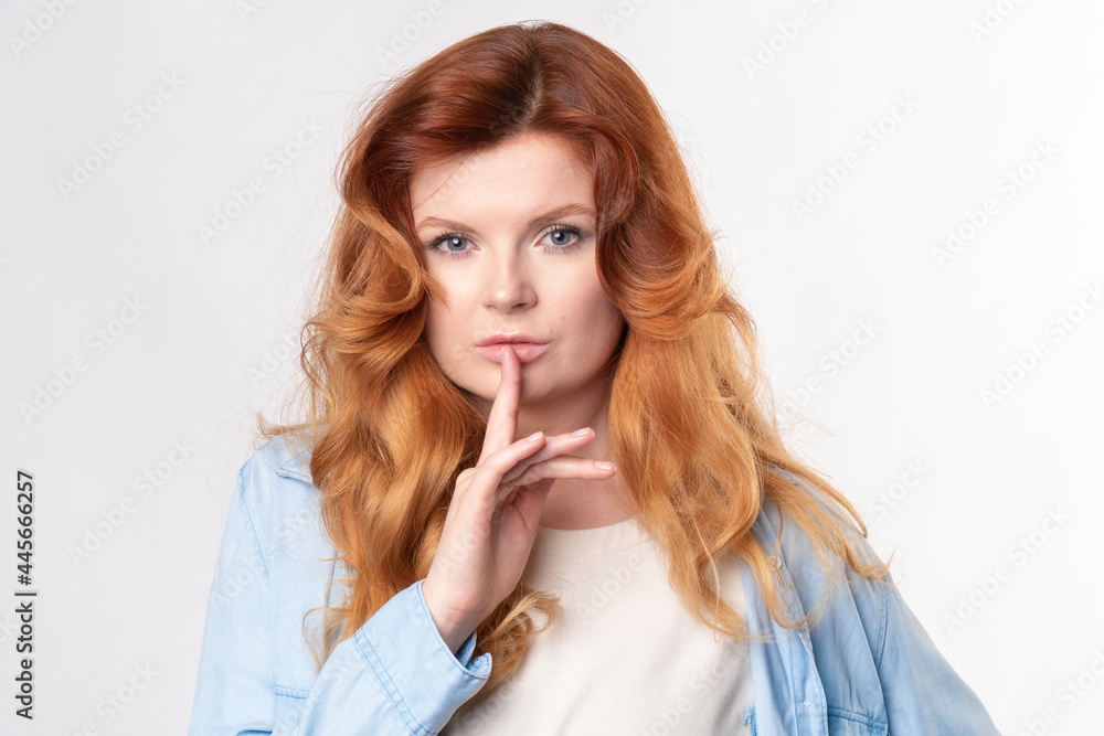 Portrait of young business woman keeping finger on her lips and asking to keep quiet, isolated over white background Portrait of young business woman keeping finger on her lips and asking to keep quiet, isolated over white background