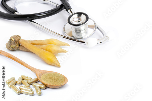 Fingerroot (Chinese Ginger, Galingale, Kaempfer, Boesenbergia rotunda, Krachai) with finger root powder nerbal capsules and medical stethoscope isolated on white photo