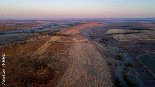 View from above. Endless plowed fields in autumn. Waste agricultural fields.