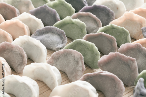Multi grain and color uncooked freshly wrapped dumplings close up. Chinese food.